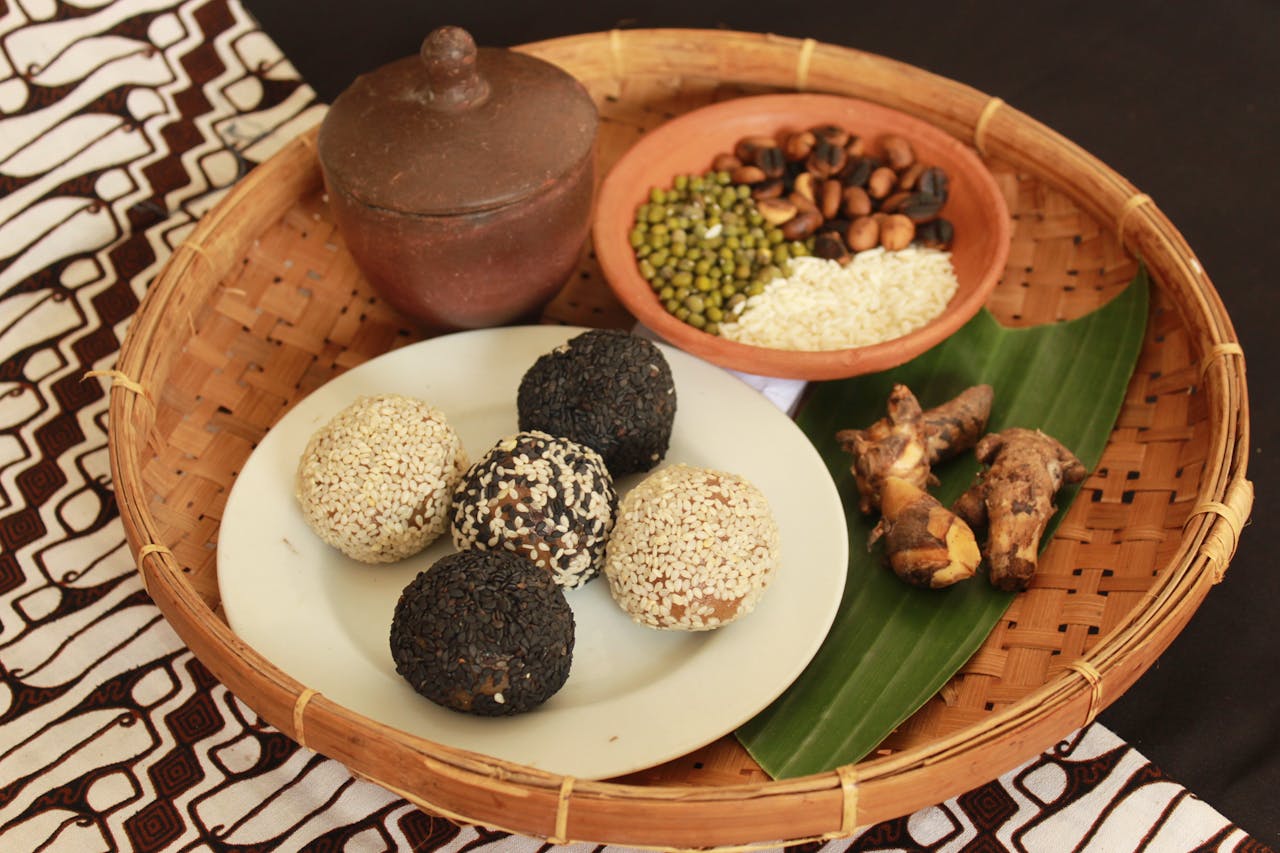 Close-up of Indonesian snacks, seeds, and spices in a woven basket setting. Perfect for culinary exploration.
