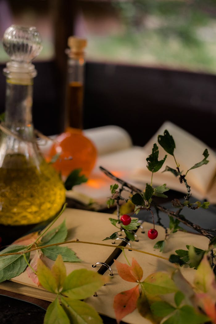 Artistic autumn-themed still life with leaves, berries, and glass bottles.
